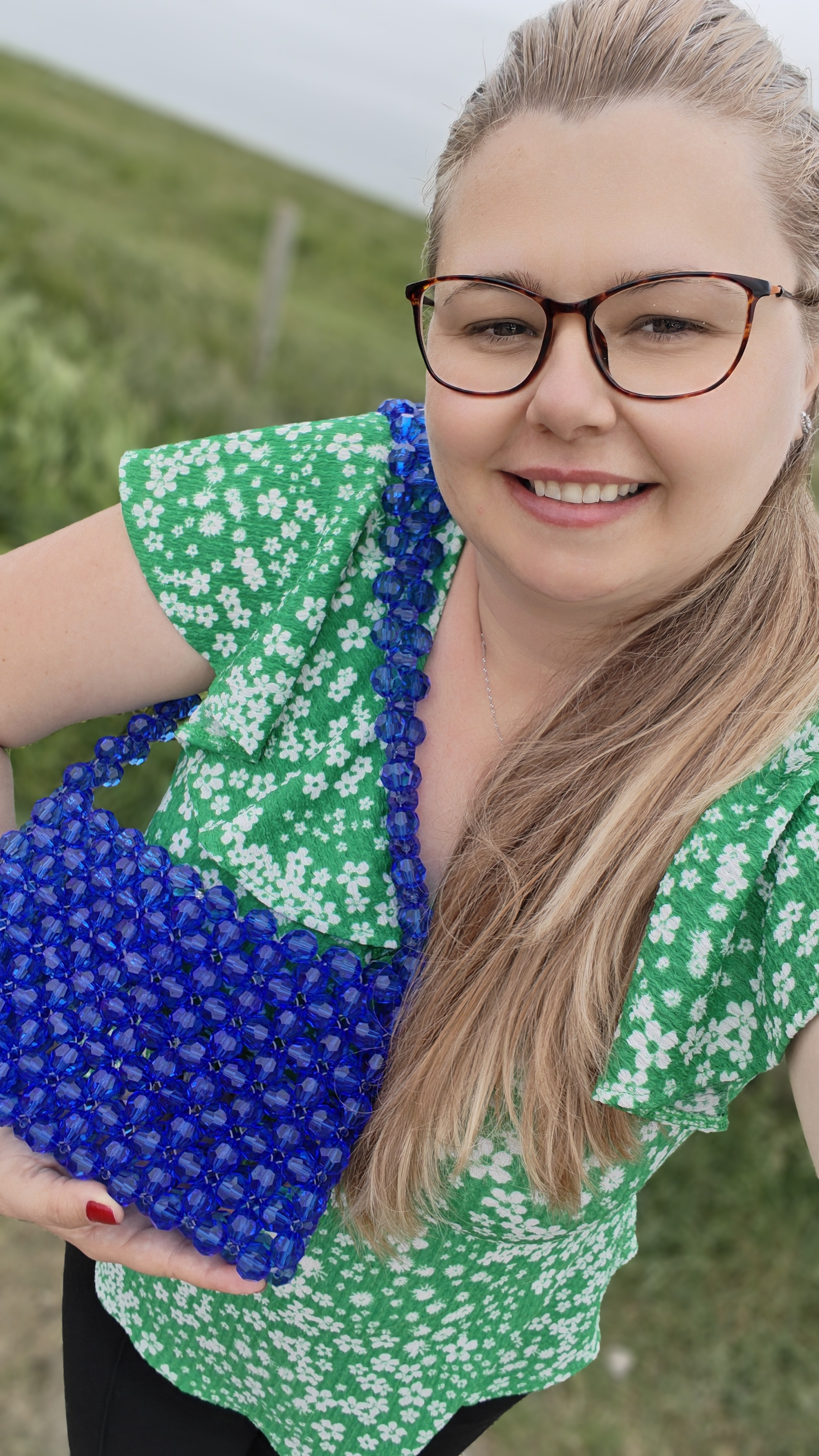 A joyful moment with the Kate Royal bag — a handcrafted blue beaded piece creat…